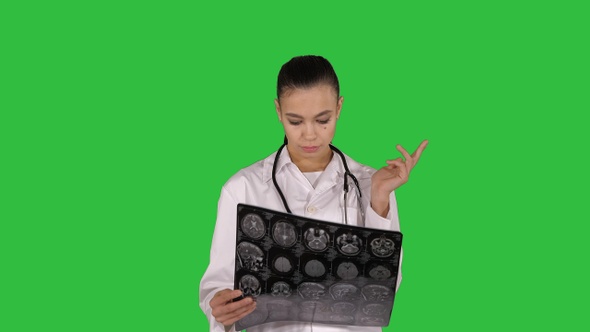 Doctor female with white labcoat looking at x-ray radiographic