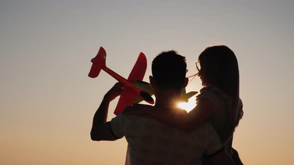 Father and Daughter Play Planes Together in the Sun's Rays