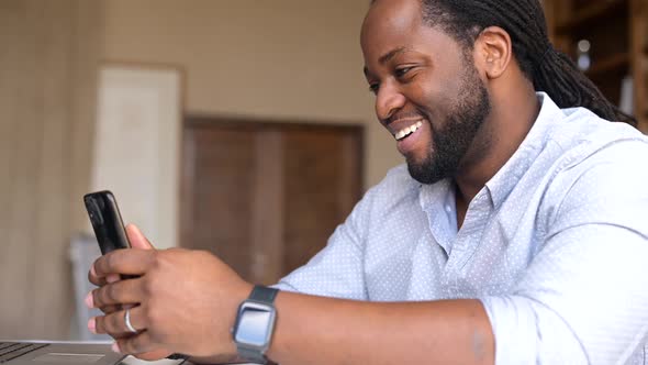 Cheerful AfricanAmerican Guy Chatting Online