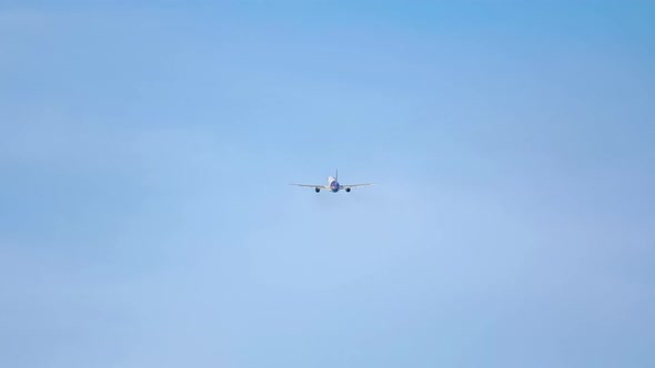 Plane Flies Away in the Sky