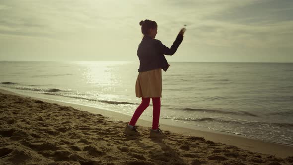 Happy Kid Playing Alone on Sea Beach