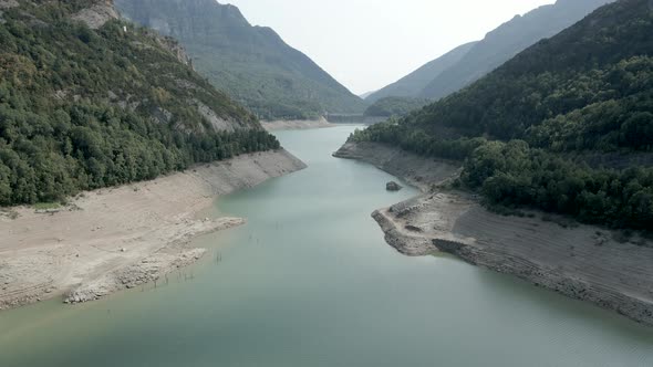 Drone Forwarding Shot Over the Verticaly Long Lake Ayous with Receding Level Water During Autumn