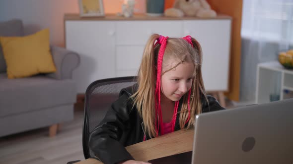 Satisfied Addicted Teenager Plays Video Games on Laptop Fashionable Girl with Pink Pigtails Actively