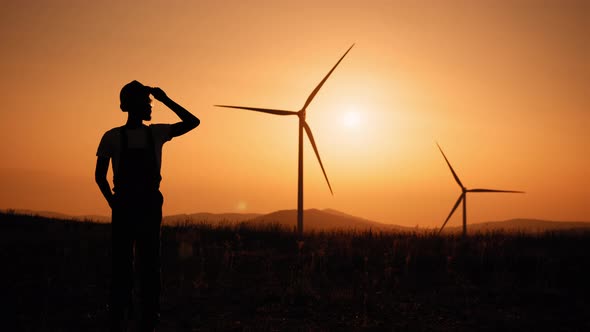 Silhouette Cinematic Shot of Young Engineer Putting Security Helmet on Satisfied