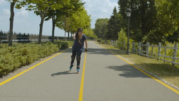 Cheerful Woman Roller Having Fun Skating in Park