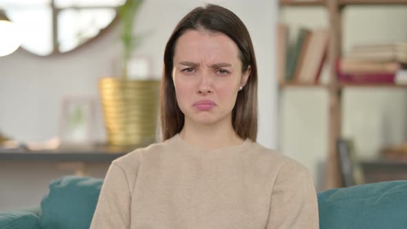 Portrait of Upset Young Woman Feeling Sad at Home 