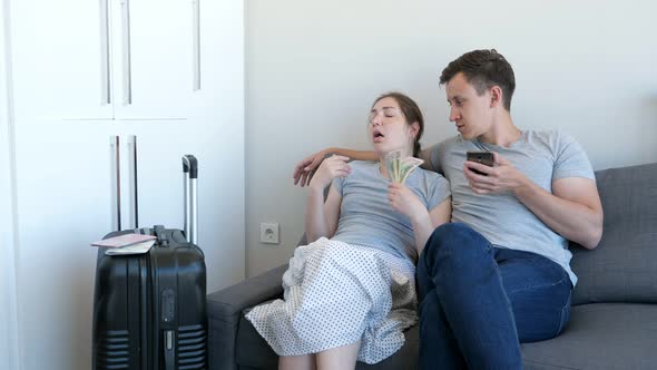 Man and Woman Choose Budget Hotel for Rest Counting Money Using Smartphone.