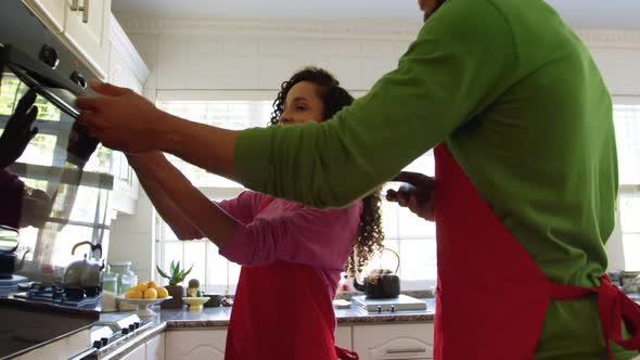 Couple making Christmas cookies at home