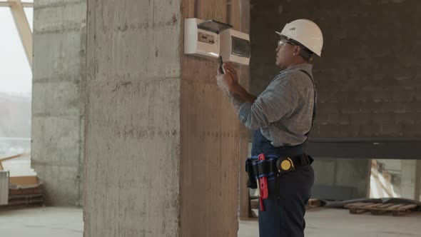 Female Worker Interacting with Control Panel