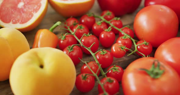 Video of fresh fruit and vegetables over wooden background