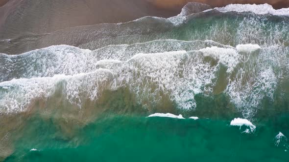 Aerial View of the Mediterranean Coast Waves Reach the Deserted Sandy Beach