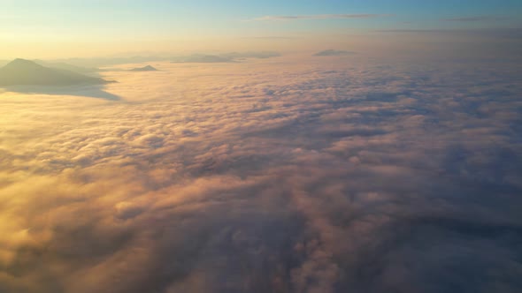 4K Drone Flying in the clouds. Flying through the clouds during sunrise