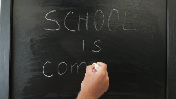 School is coming written on chalkboard