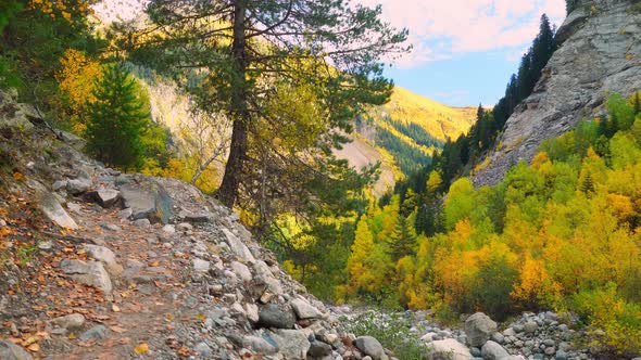 young tourist walks through mountainous area and looks at beautiful landscape.