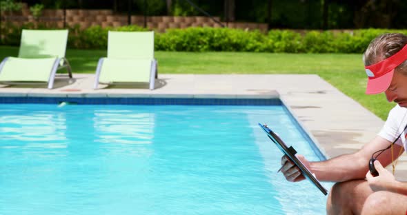 Lifeguard holding clipboard and looking at stop watch