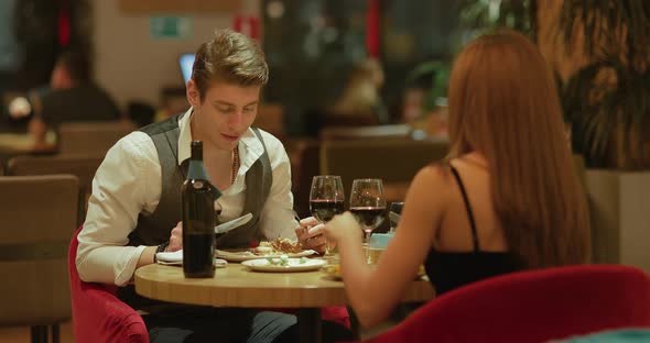 Young Man with a Woman Having Dinner in an Expensive Restaurant a Romantic Date