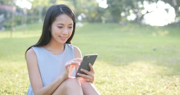 Woman use of smart phone in the park