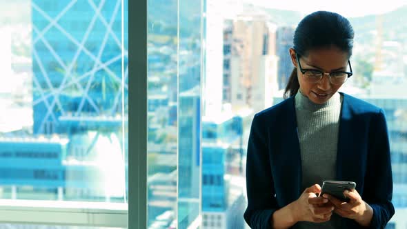 Female executive using mobile phone