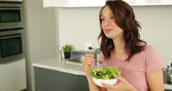 Pretty Woman Eating a Bowl of Healthy Salad