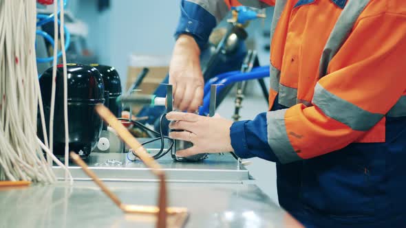 Cooling Mechanism is Getting Regulated By a Factory Worker