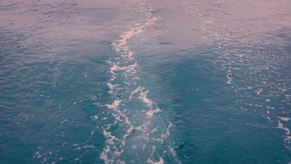 Wake Behind Boat At Sunrise