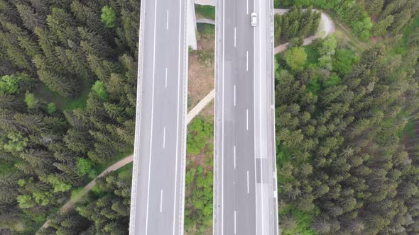 Aerial Top View of Highway Viaduct with Multilane Traffic in Mountains. Autobahn in Austria