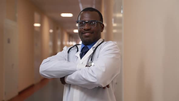 Young Male African Doctor is Posing for Camera During Working Day in Modern Hospital Spbas