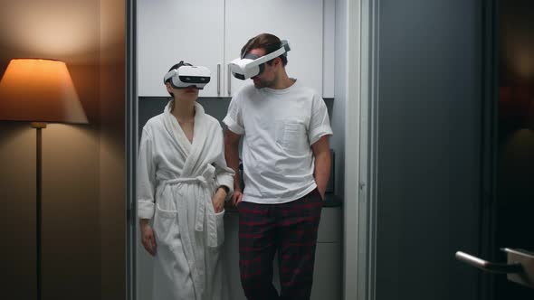 Young Couple in Vr Headset Standing in Kitchen and Talking