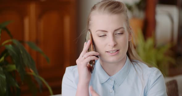 Woman Talking on Mobile at Home