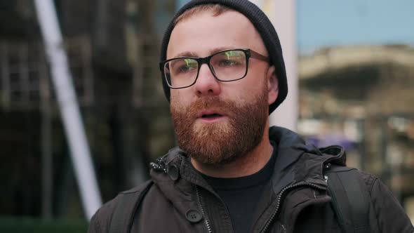 Close Up View of Bearded Man Looking Gloomy and Worried While Walking at Street. Portrait of