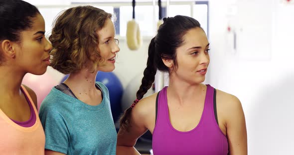 Beautiful women interacting with each other in fitness studio