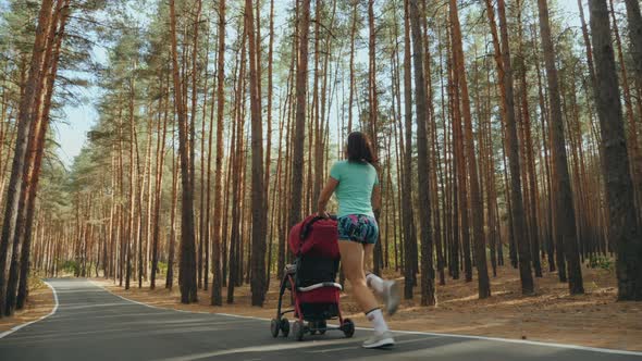 Running Woman with Baby Stroller on the Road in Forest