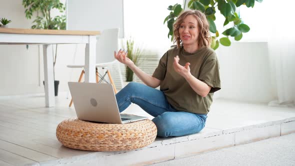 Woman Using Laptop Computer While Sitting Floor at Home Interior