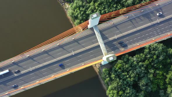 Aerial View of Traffic on highway road. Bridge over river. Dark water.