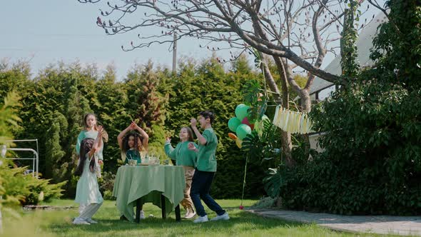 Children Having Fun Jumping at the Birthday Party at the Backyard on a Sunny Day