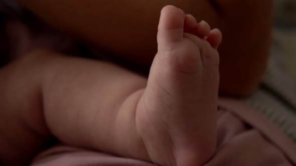 Baby Feet On Mother Hands
