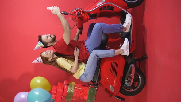 Portrait Young Couple Scooter Delivery Colorful Balloons Gifts Online Order Isolated Red Background