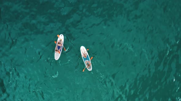 Aerial View of the People on Canoes Within Turquoise Sea Waters