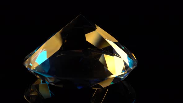 Diamond Slowly Rotates with a Sharp End Up. Black Background