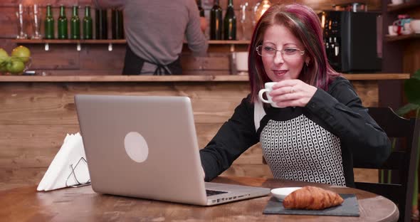 Adult Businesswoman Pays for Coffee Using a Contactless Credit Card