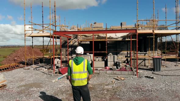 Male engineer looking at construction site on a sunny day 4k