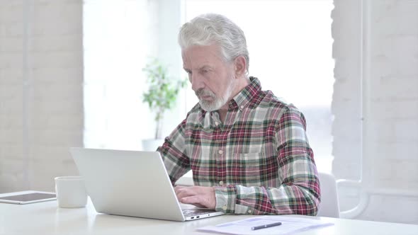 Casual Old Man Working on Laptop