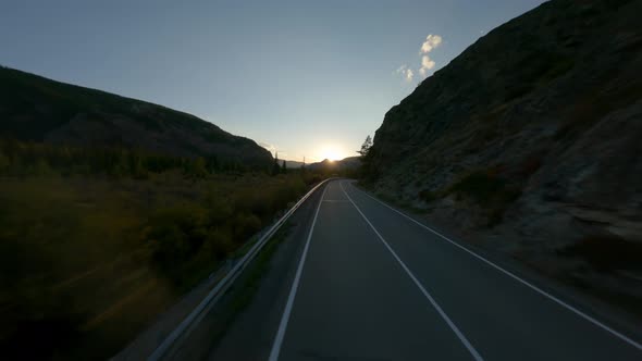 Aerial View Flying Over Road Highway Near Natural Mountain at Sunset Sunrise Sun Vivid Landscape