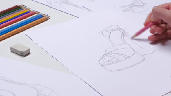 Designer Draws Sketches of Fashionable Shoes and Decorate in Pink. Close Up