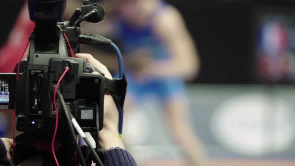 Cameraman with a Camera in Wrestling Competitions. Close-up.