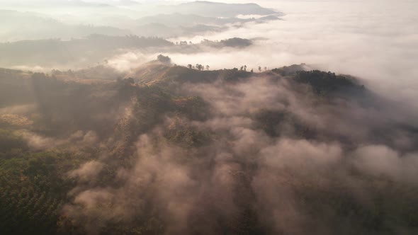 4K Aerial view from drone over mountains fog. Golden scenery at sunrise, Nan, Thailand