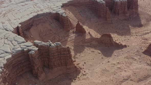 Orbiting aerial view of unique sandstone rock formations in the Utah desert near Hanksville Utah