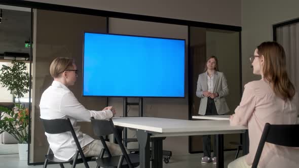 Diverse office conference room meeting: female project manager uses Chroma Key wall mounted