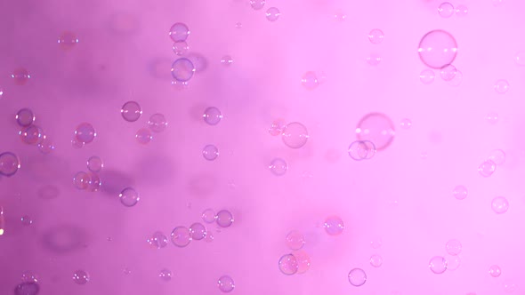 Blue and Clear Soap Bubbles on Pink, Background