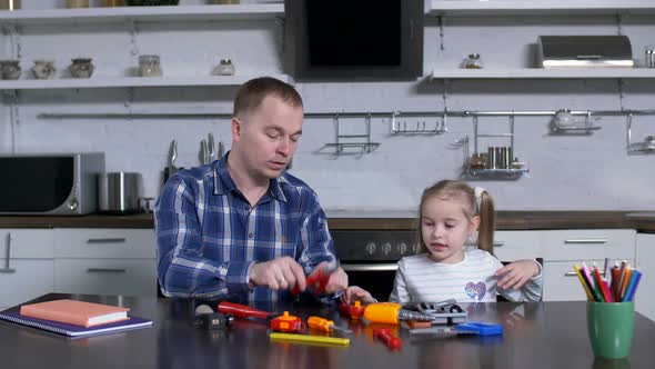 Dad with Preteen Daughter During Home Shop Class